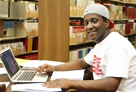 LRU student in library at table